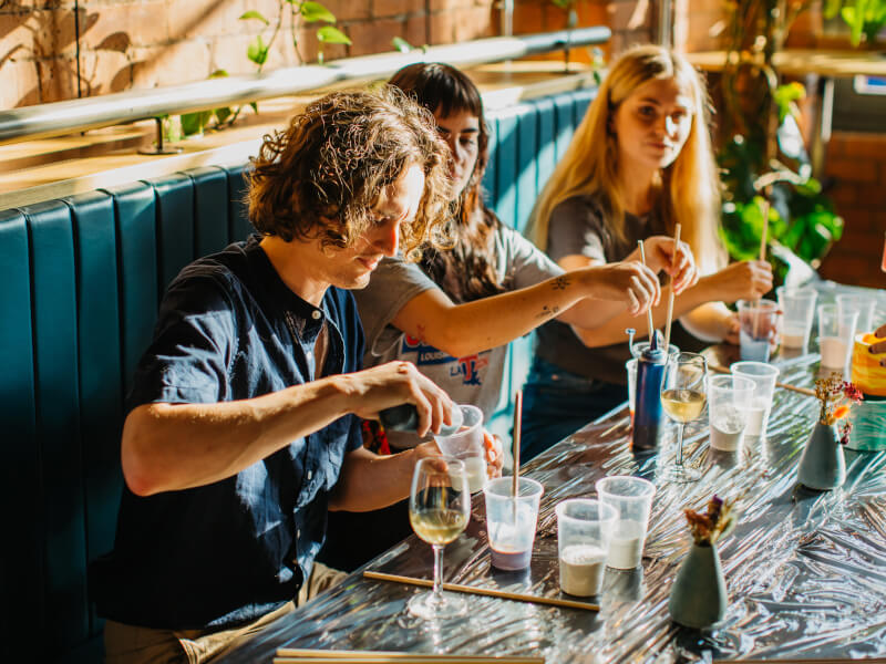 Three young people doing resin art